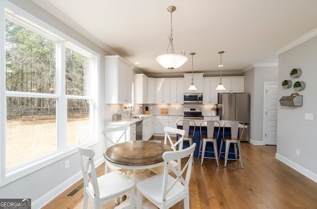15 Jamilee Cv, Cartersville, GA 30120 - dining space with baseboards, dark wood-style floors, and ornamental molding