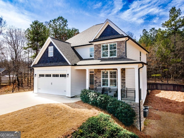 15 Jamilee Cv, Cartersville, GA 30120 - view of front of home with covered porch, stone siding, concrete driveway, a garage, and roof with shingles