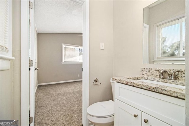 2641 Clifton Springs Rd, Decatur, GA 30034 - half bathroom featuring toilet, vanity, healthy amount of natural light, and baseboards