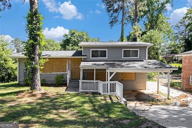 2641 Clifton Springs Rd, Decatur, GA 30034 - split level home with concrete driveway, an attached carport, a front lawn, brick siding, and a chimney