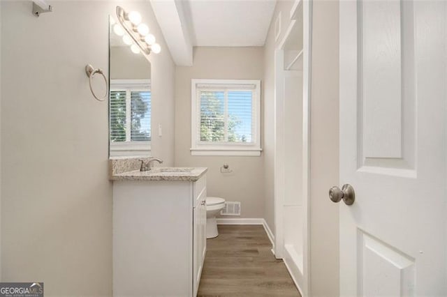 2641 Clifton Springs Rd, Decatur, GA 30034 - bathroom featuring toilet, vanity, wood finished floors, and baseboards
