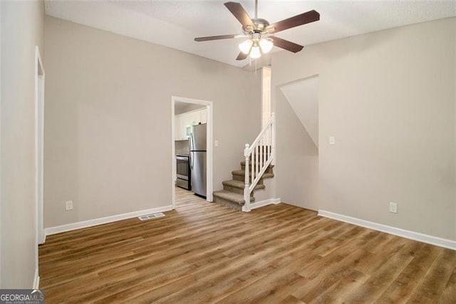2641 Clifton Springs Rd, Decatur, GA 30034 - spare room featuring ceiling fan, wood finished floors, stairs, and baseboards