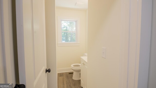 71 Cold Springs Rd, Warm Springs, GA 31830 - half bathroom featuring vanity, toilet, wood finished floors, and baseboards