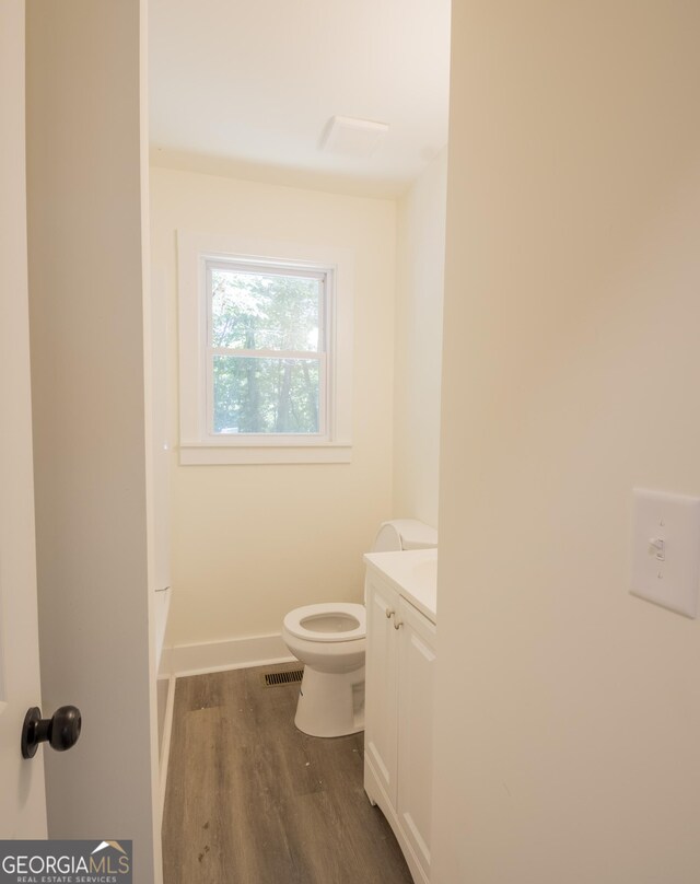 71 Cold Springs Rd, Warm Springs, GA 31830 - bathroom featuring toilet, vanity, wood finished floors, and baseboards