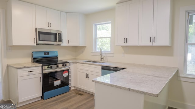 71 Cold Springs Rd, Warm Springs, GA 31830 - kitchen featuring appliances with stainless steel finishes, a sink, a peninsula, white cabinets, and light wood-style flooring
