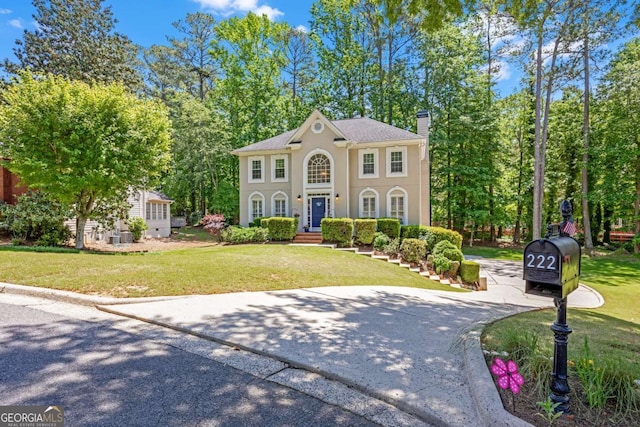 222 Mossy Pl, Alpharetta, GA 30005 - view of front facade with a chimney, a front lawn, and stucco siding