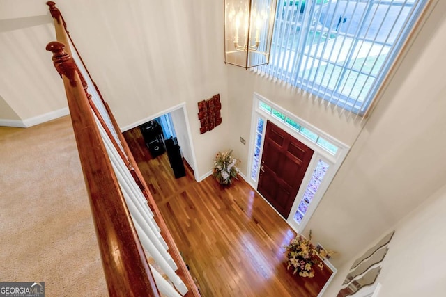 222 Mossy Pl, Alpharetta, GA 30005 - foyer entrance featuring baseboards, a high ceiling, a chandelier, and wood finished floors