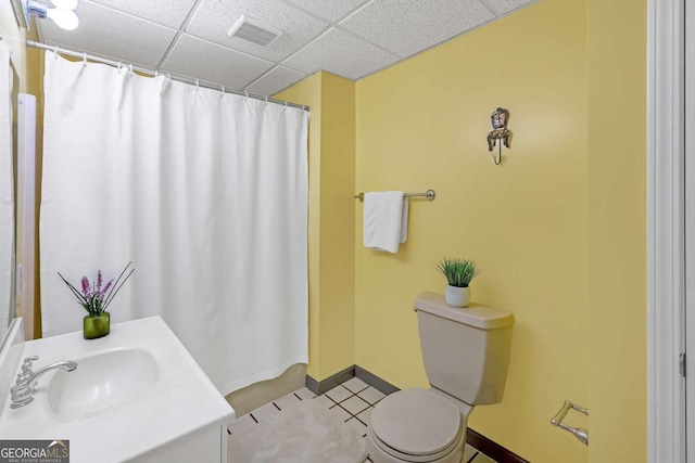 222 Mossy Pl, Alpharetta, GA 30005 - full bath featuring toilet, vanity, baseboards, a drop ceiling, and tile patterned floors