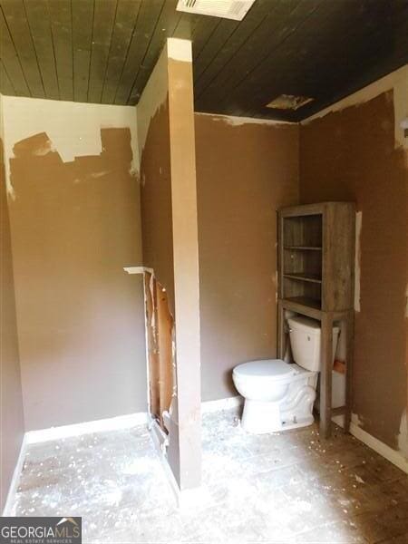 1306 Stonemont Rd, Auburn, GA 30011 - bathroom with wood ceiling, toilet, and baseboards