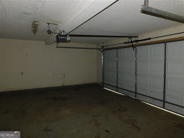 1306 Stonemont Rd, Auburn, GA 30011 - garage featuring a garage door opener