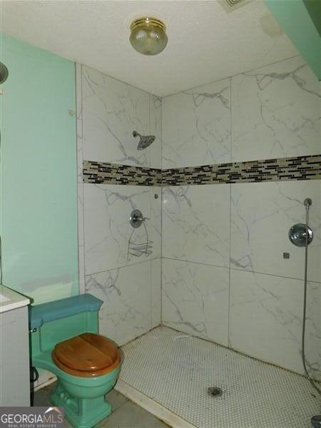 1306 Stonemont Rd, Auburn, GA 30011 - full bathroom featuring a tile shower and toilet