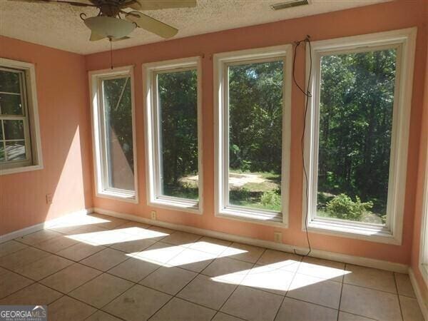 1306 Stonemont Rd, Auburn, GA 30011 - doorway with baseboards, light tile patterned flooring, a textured ceiling, and ceiling fan