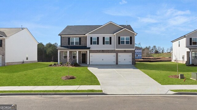 712 Curb Ct, Locust Grove, GA 30248 - view of front of home with driveway, a garage, and a front lawn