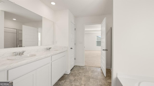 712 Curb Ct, Locust Grove, GA 30248 - full bathroom with double vanity, recessed lighting, baseboards, and a shower