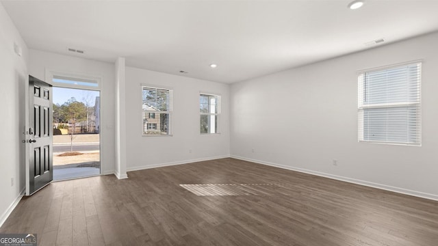 712 Curb Ct, Locust Grove, GA 30248 - unfurnished room with dark wood finished floors, baseboards, recessed lighting, and plenty of natural light