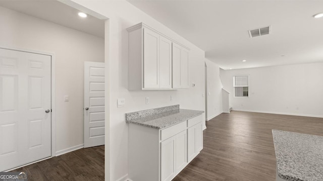 712 Curb Ct, Locust Grove, GA 30248 - kitchen featuring dark wood finished floors, white cabinetry, baseboards, light stone counters, and recessed lighting