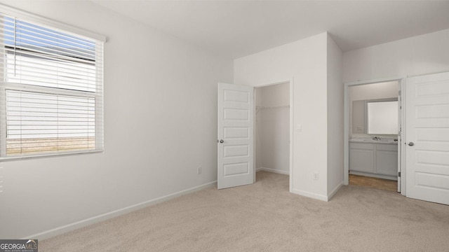 712 Curb Ct, Locust Grove, GA 30248 - unfurnished bedroom featuring light carpet, baseboards, a closet, and a spacious closet