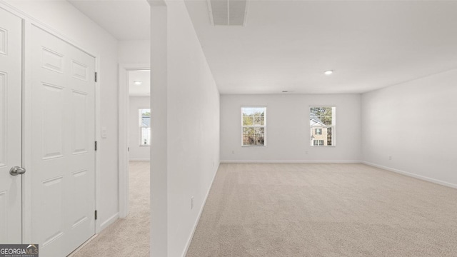 712 Curb Ct, Locust Grove, GA 30248 - empty room with light colored carpet, healthy amount of natural light, baseboards, and recessed lighting