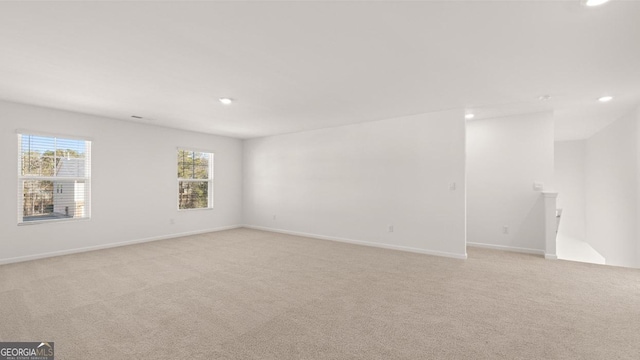712 Curb Ct, Locust Grove, GA 30248 - spare room featuring light carpet, recessed lighting, and baseboards