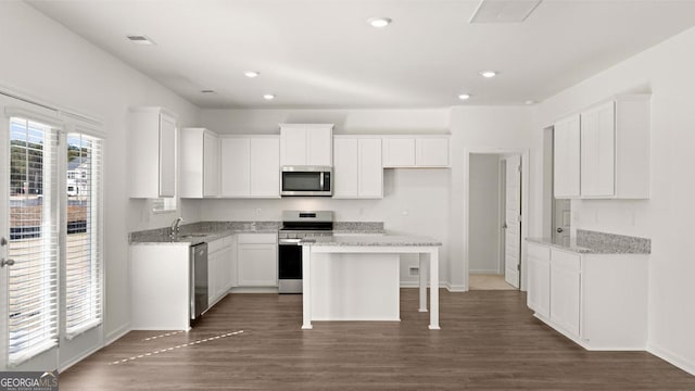 712 Curb Ct, Locust Grove, GA 30248 - kitchen featuring appliances with stainless steel finishes, white cabinets, baseboards, dark wood-type flooring, and recessed lighting