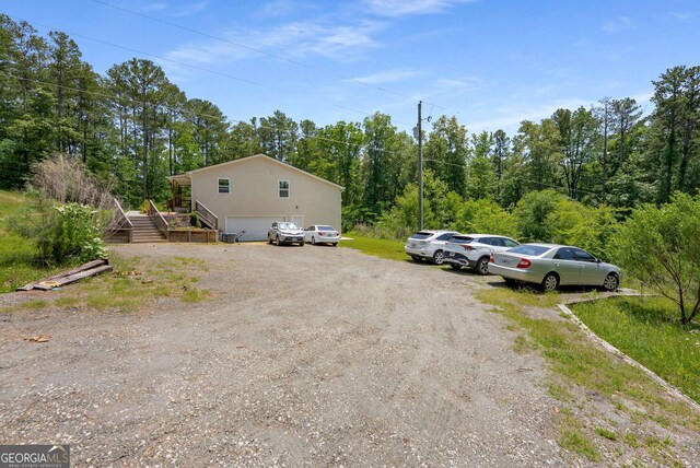 212 Postell Rd, Dallas, GA 30157 - view of vehicle parking featuring stairway and an attached garage