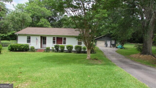 215 Poplar Cir, Lagrange, GA 30241 - ranch-style house featuring a front yard, an outbuilding, and a detached garage