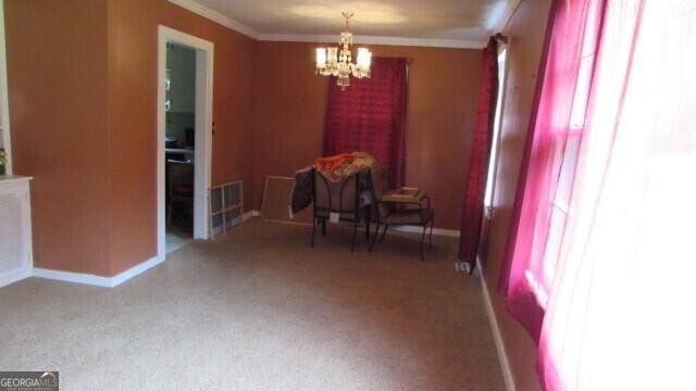 215 Poplar Cir, Lagrange, GA 30241 - dining space with healthy amount of natural light, a chandelier, ornamental molding, baseboards, and carpet floors