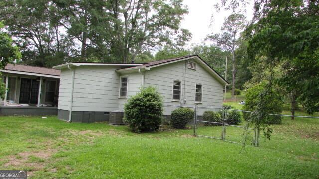 215 Poplar Cir, Lagrange, GA 30241 - view of side of home featuring a gate, central AC, crawl space, and a sunroom