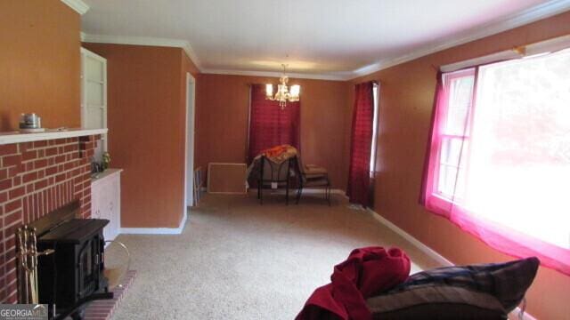 215 Poplar Cir, Lagrange, GA 30241 - carpeted living area with plenty of natural light, a chandelier, crown molding, baseboards, and a fireplace