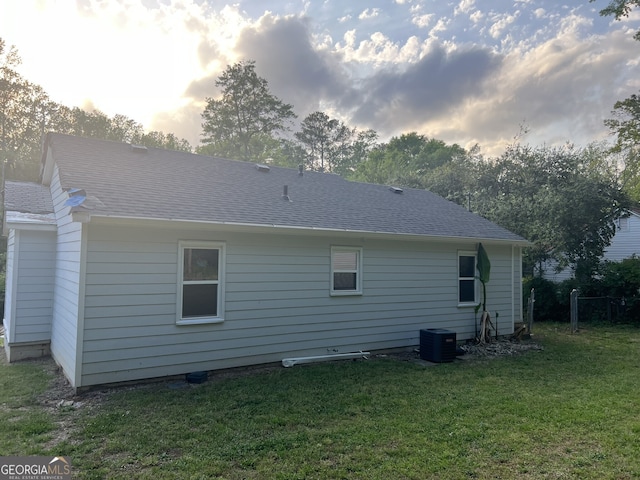 3831 Dillard St, Powder Springs, GA 30127 - rear view of house featuring a lawn, central AC, and roof with shingles