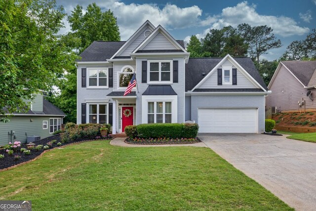 4174 Chatham Crest Ln, Buford, GA 30518 - traditional home with concrete driveway, a front yard, brick siding, and roof with shingles