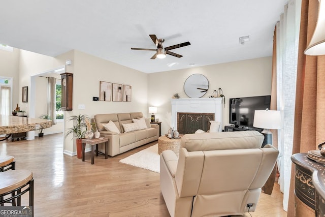 4174 Chatham Crest Ln, Buford, GA 30518 - living area with a ceiling fan, light wood-type flooring, a fireplace, and baseboards