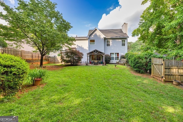 4174 Chatham Crest Ln, Buford, GA 30518 - back of house featuring a chimney, a patio, and a gate