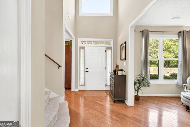 4174 Chatham Crest Ln, Buford, GA 30518 - entrance foyer with light wood finished floors, stairs, baseboards, and a high ceiling