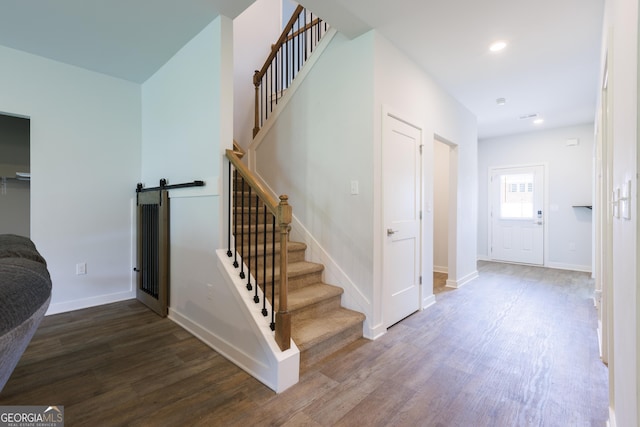 1225 Hibiscus Way, Mcdonough, GA 30253 - stairs featuring wood finished floors, baseboards, a barn door, and recessed lighting