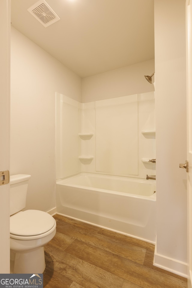 1225 Hibiscus Way, Mcdonough, GA 30253 - full bath featuring wood finished floors, toilet, bathtub / shower combination, and baseboards