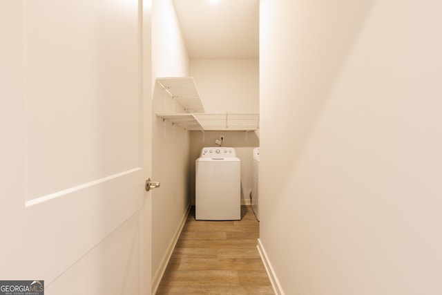 1225 Hibiscus Way, Mcdonough, GA 30253 - laundry room featuring separate washer and dryer, light wood finished floors, and baseboards