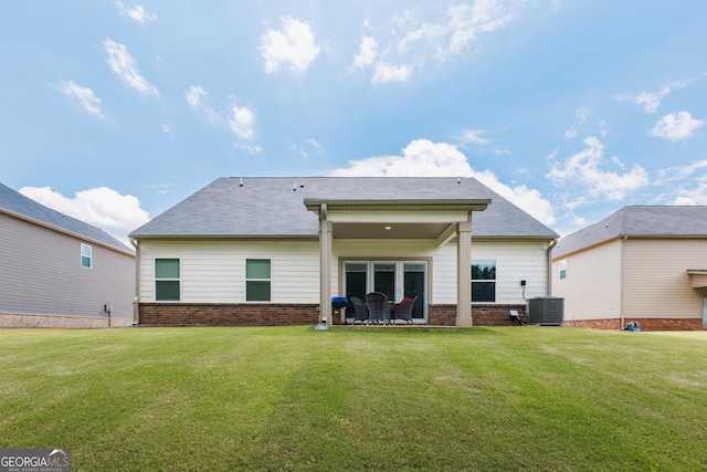 1225 Hibiscus Way, Mcdonough, GA 30253 - back of house featuring a yard, central air condition unit, brick siding, and a patio