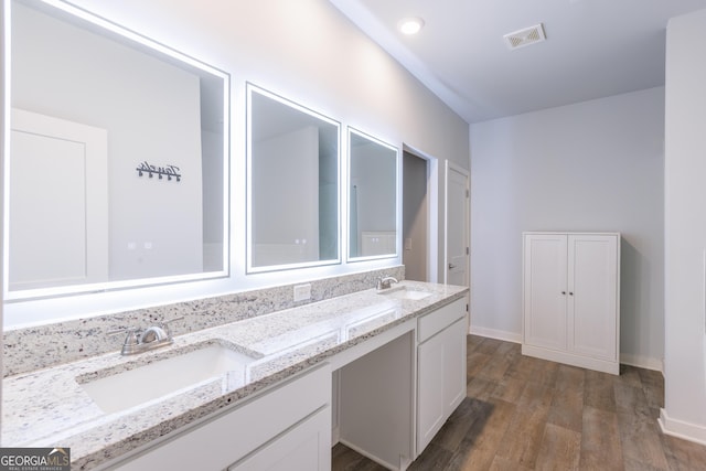 1225 Hibiscus Way, Mcdonough, GA 30253 - full bathroom featuring double vanity, wood finished floors, and baseboards