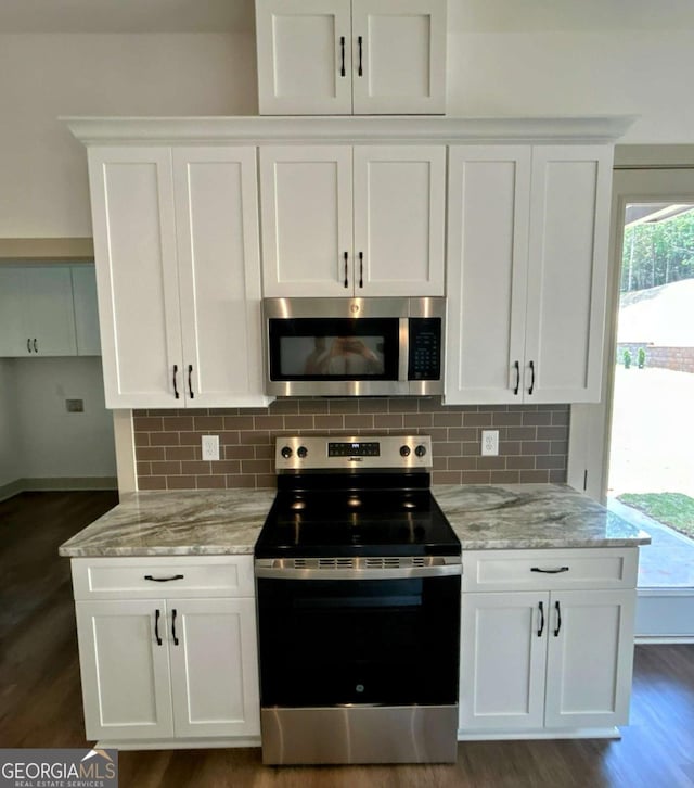 297 Ayers Creek Dr, Toccoa, GA 30577 - kitchen with stainless steel appliances, dark wood-type flooring, white cabinets, and light stone counters