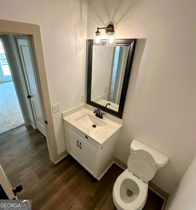 297 Ayers Creek Dr, Toccoa, GA 30577 - half bath with vanity, wood finished floors, toilet, and baseboards