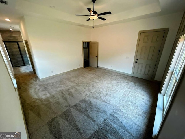 297 Ayers Creek Dr, Toccoa, GA 30577 - unfurnished bedroom featuring light colored carpet, a tray ceiling, and baseboards