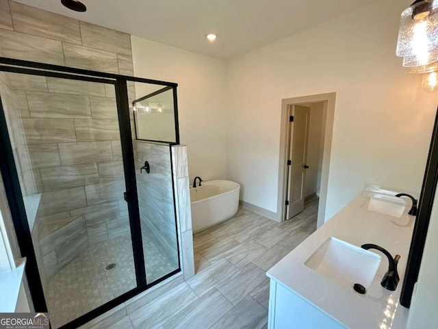 297 Ayers Creek Dr, Toccoa, GA 30577 - bathroom featuring a stall shower, double vanity, a freestanding tub, and baseboards