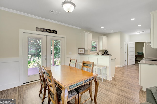 133 Coldwater Ln, Griffin, GA 30224 - dining room featuring light wood-type flooring, crown molding, and recessed lighting