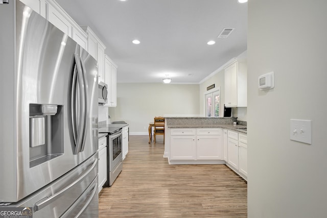 133 Coldwater Ln, Griffin, GA 30224 - kitchen with appliances with stainless steel finishes, a peninsula, white cabinetry, and recessed lighting
