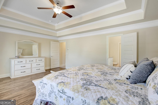 133 Coldwater Ln, Griffin, GA 30224 - bedroom featuring a raised ceiling, crown molding, wood finished floors, ensuite bath, and a ceiling fan