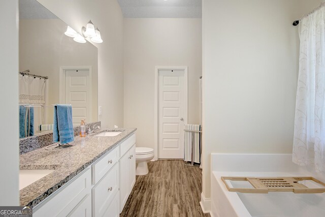 133 Coldwater Ln, Griffin, GA 30224 - bathroom featuring double vanity, wood finished floors, and a bathtub