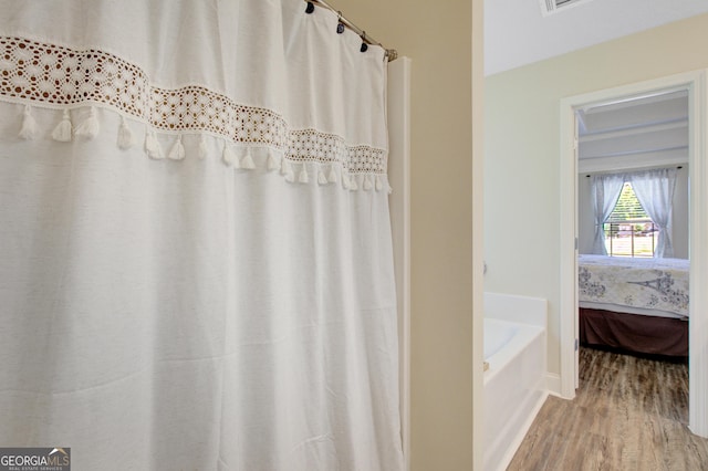 133 Coldwater Ln, Griffin, GA 30224 - bathroom featuring wood finished floors, a bath, and ensuite bath