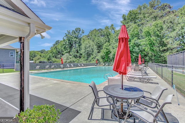 133 Coldwater Ln, Griffin, GA 30224 - community pool featuring a patio area and view of scattered trees