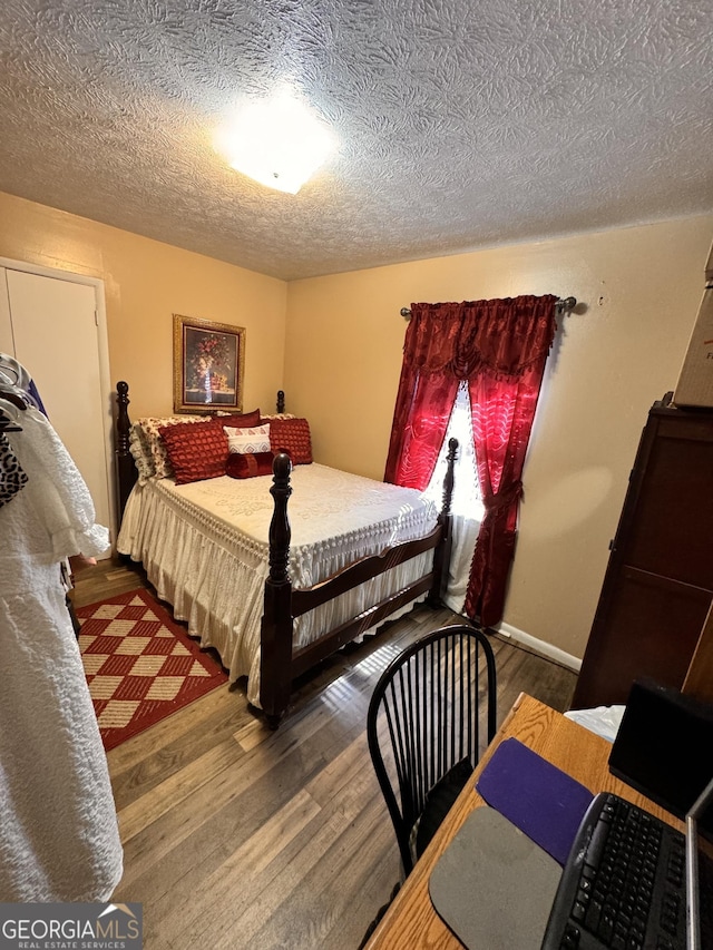 2019 Cason Dr, Vidalia, GA 30474 - bedroom featuring wood finished floors, a textured ceiling, and baseboards